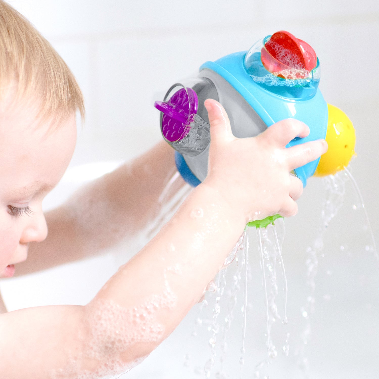 baby playing with bath toy