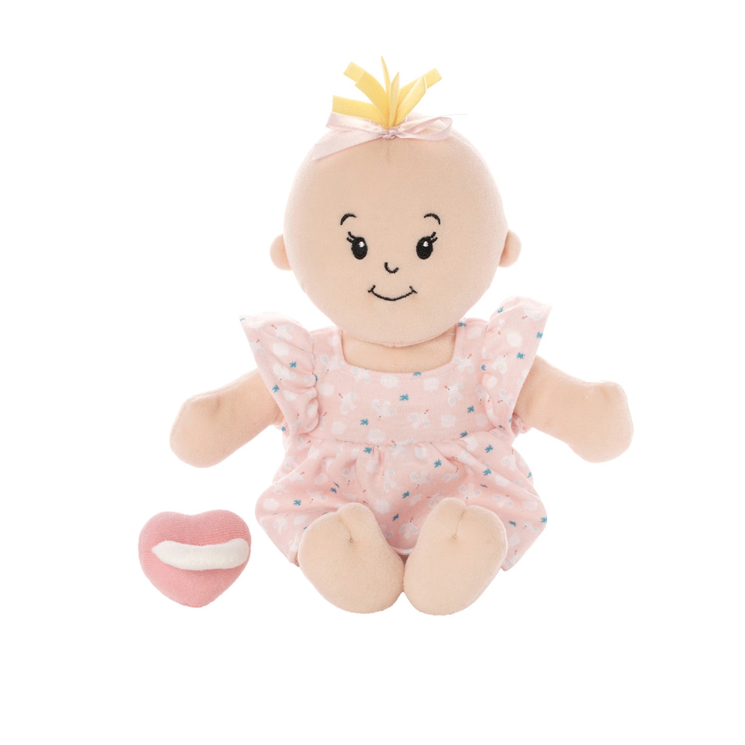 soft baby doll with peach skin and blonde hair tuft in a pink dress seated with a pink magnetic pacifier off to the side