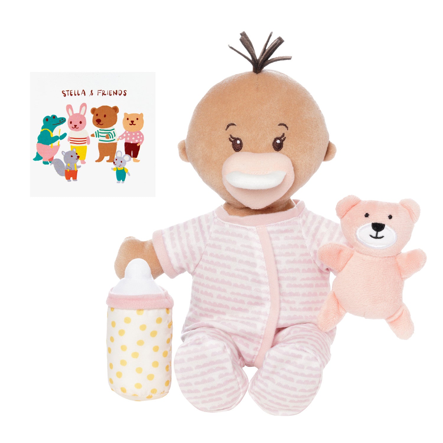 soft doll with beige skin dressed in pjs that comes with a stuffed teddy bear, baby bottle and mini paper picture book doll is seated holding teddy and bottle with magnetic pacifier on face