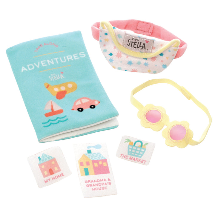 Wee Baby Stella adventure accessories including a soft book, toy fanny pack, flower sunglasses, and location cards.
