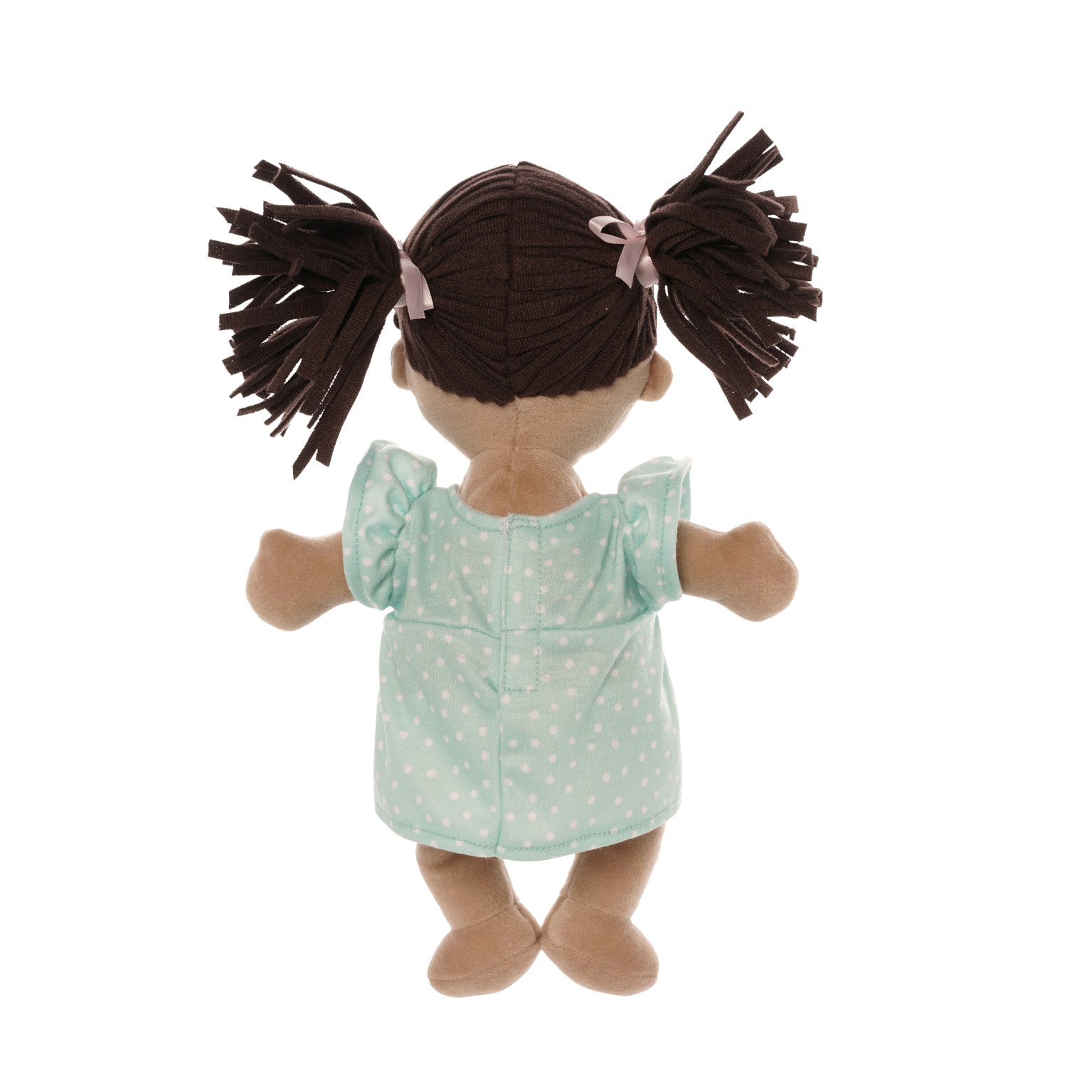 back side of soft baby doll with beige skin and brown pigtails wearing a dress with a magnetic pacifier