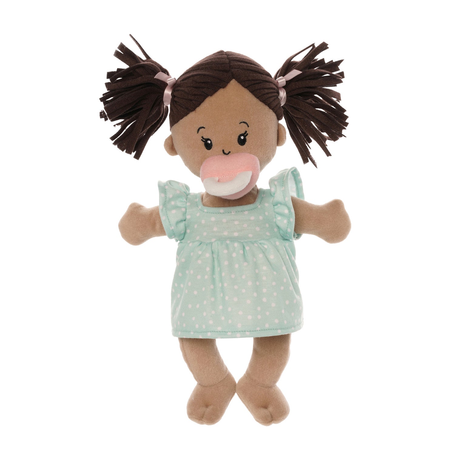 standing beige soft baby doll with brown pigtails in blue dress seated with pink magnetic pacifier attached to the face