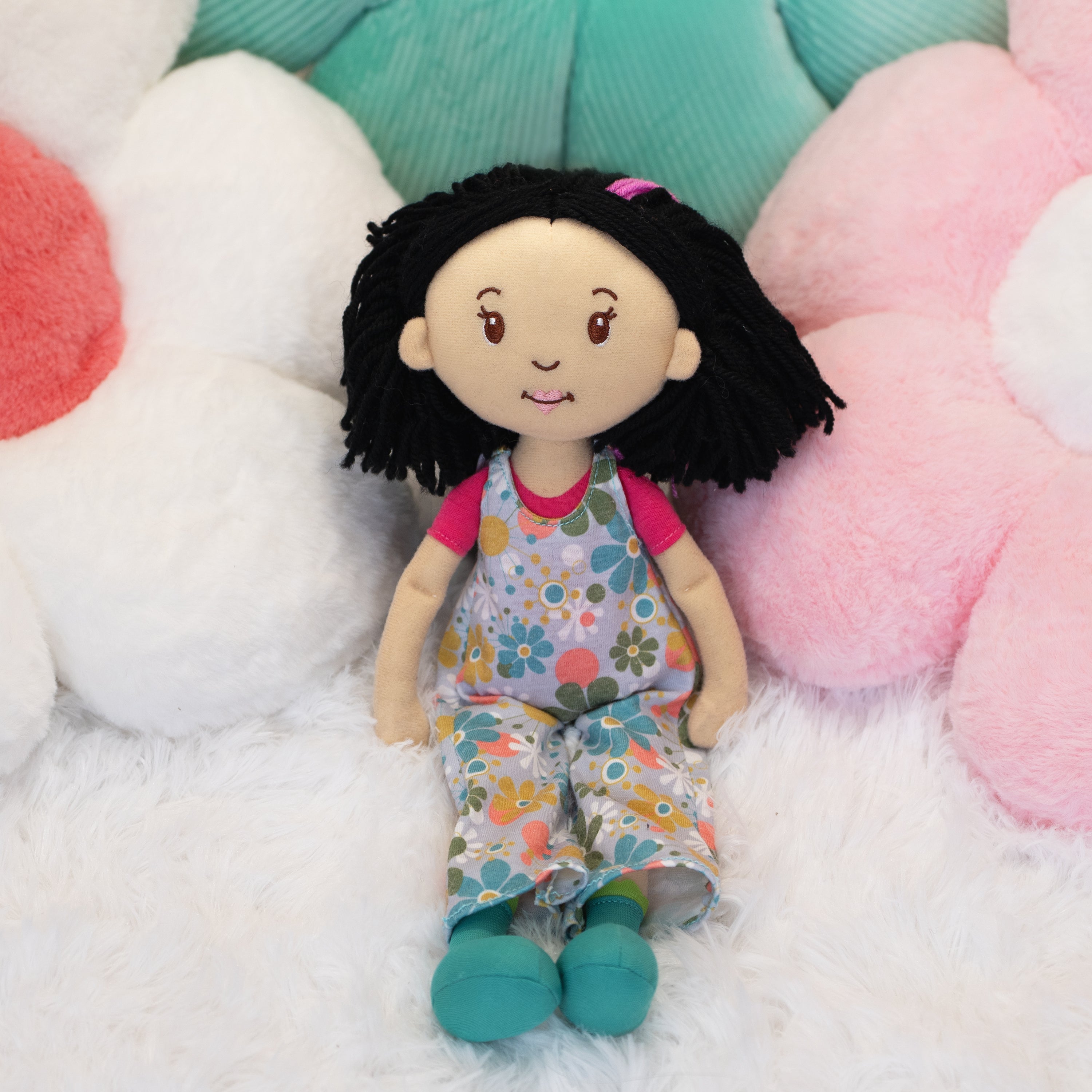 Groovy Girls Daisy doll leaning against flower shaped pillows