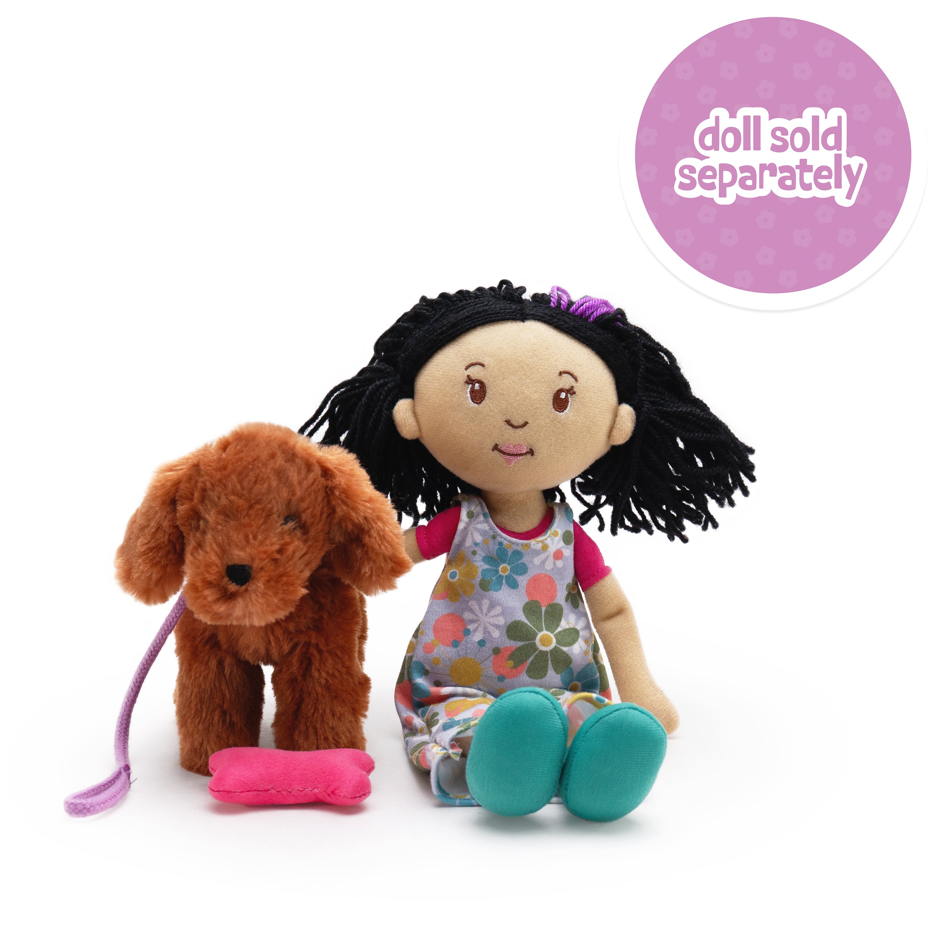 Soft doll sitting next to a soft brown dog with a pink bone in front of it. Doll sold separately callout