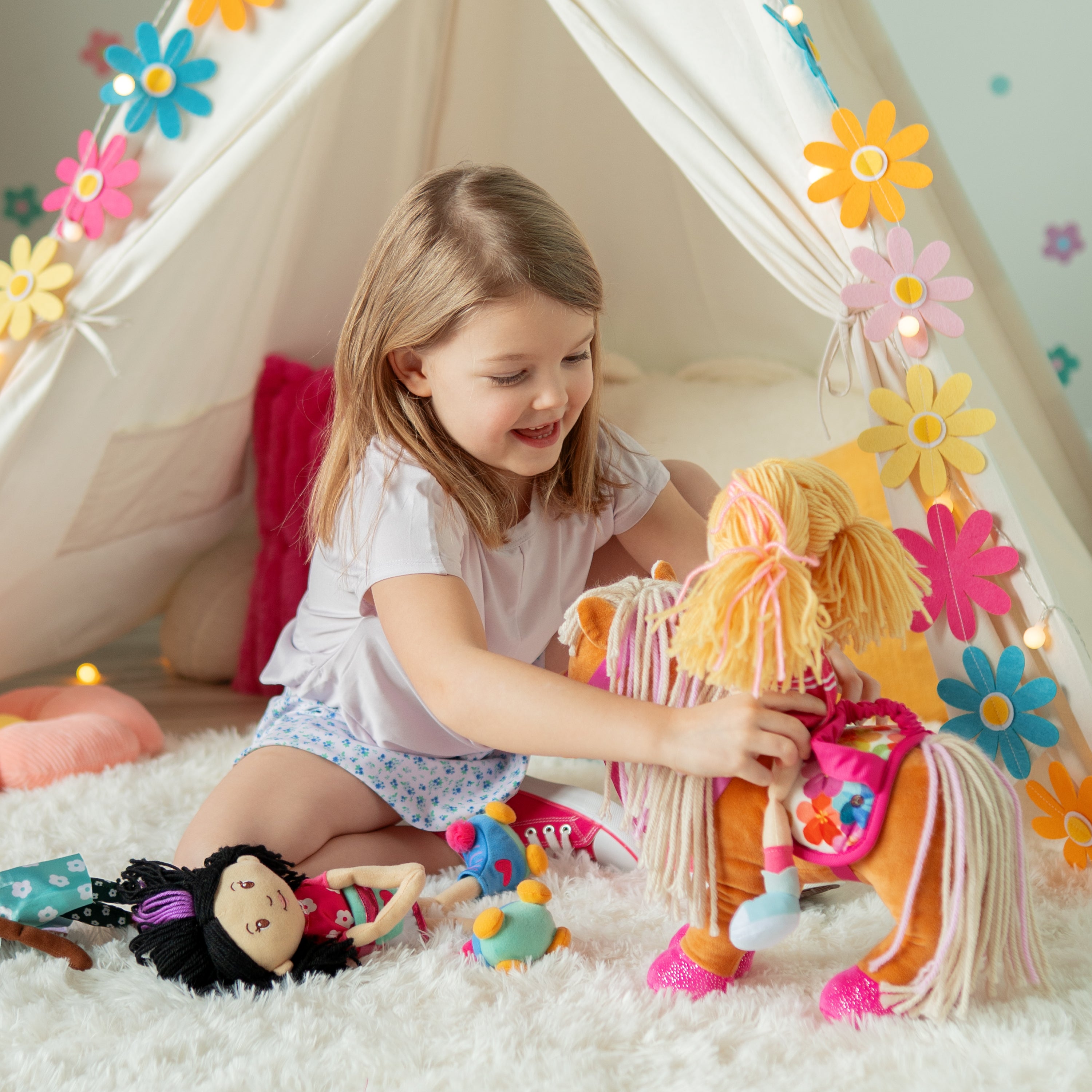 Girl playing with Groovy Girls Rose doll and Groovy Girls horse