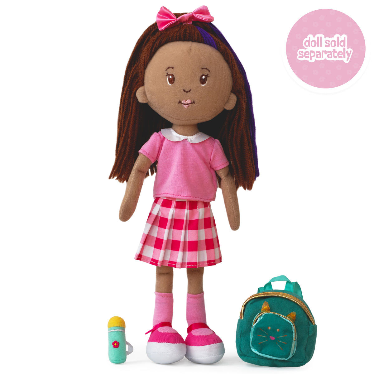 soft doll wearing a pink collared shirt and gingham skirt with a teal backpack and water bottle beside her