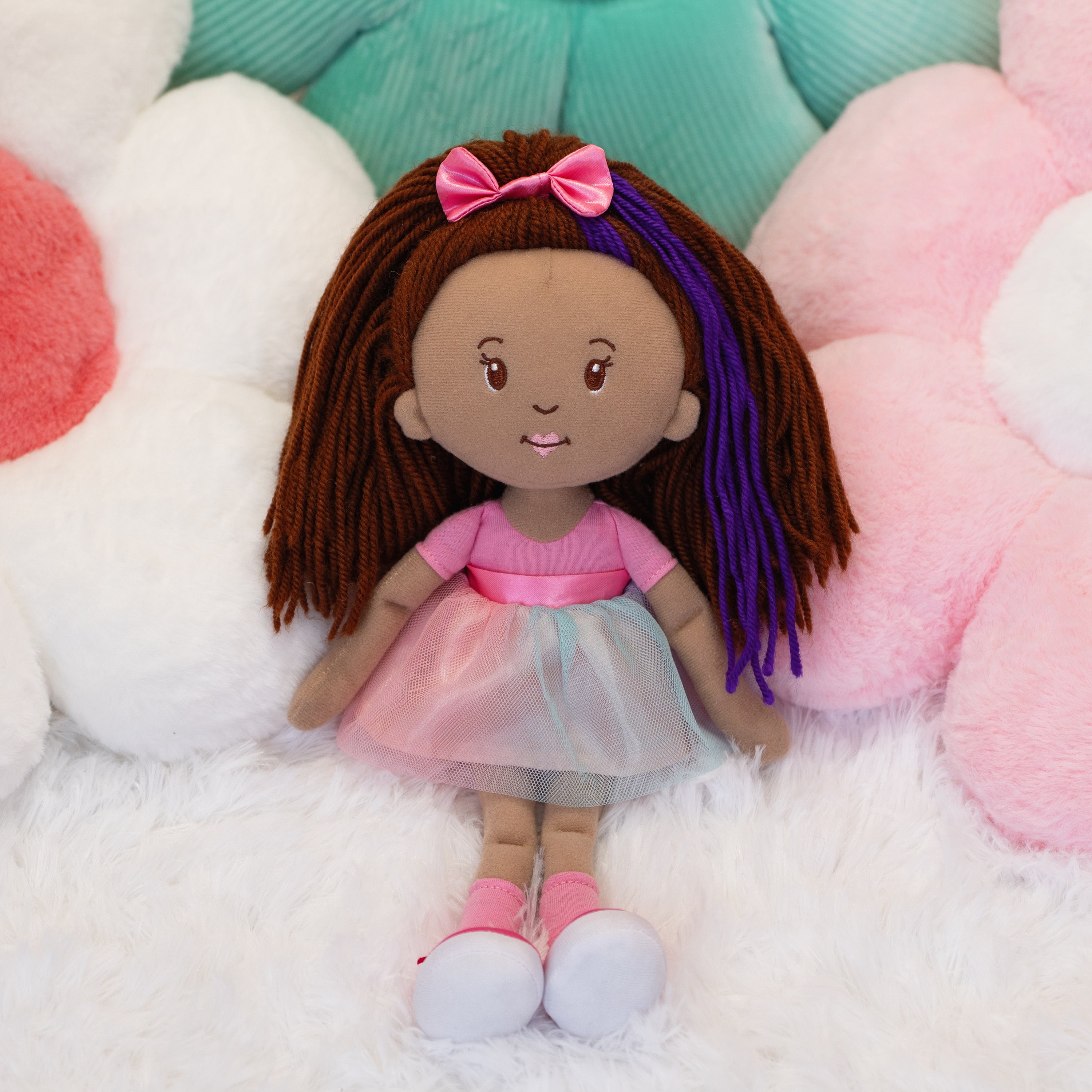 Groovy Girls Iris doll leaning on flower shaped pillows