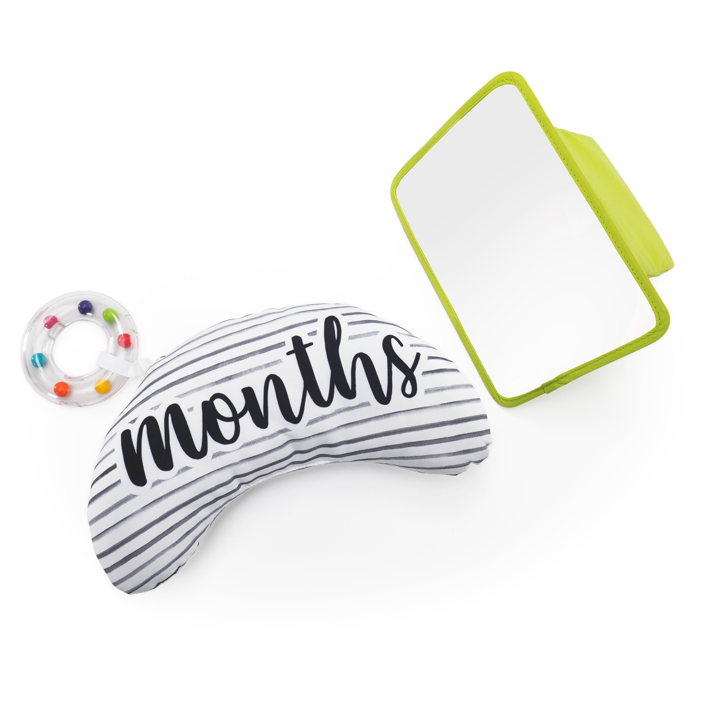 Striped bolster pillow with 'months' text, colorful ring, and green mirror on a white background