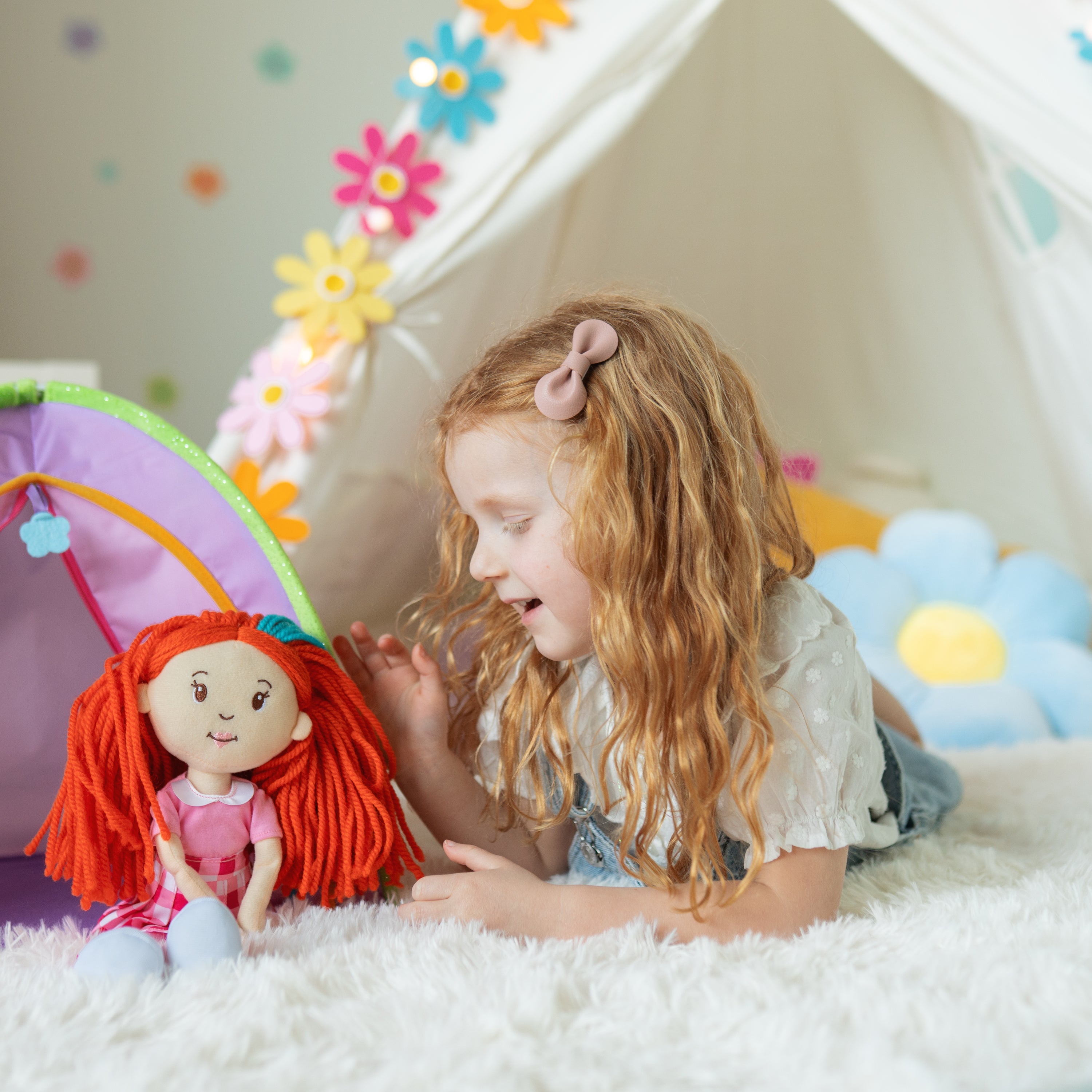 Child playing with Groovy Girls Poppy doll in a colorful play area