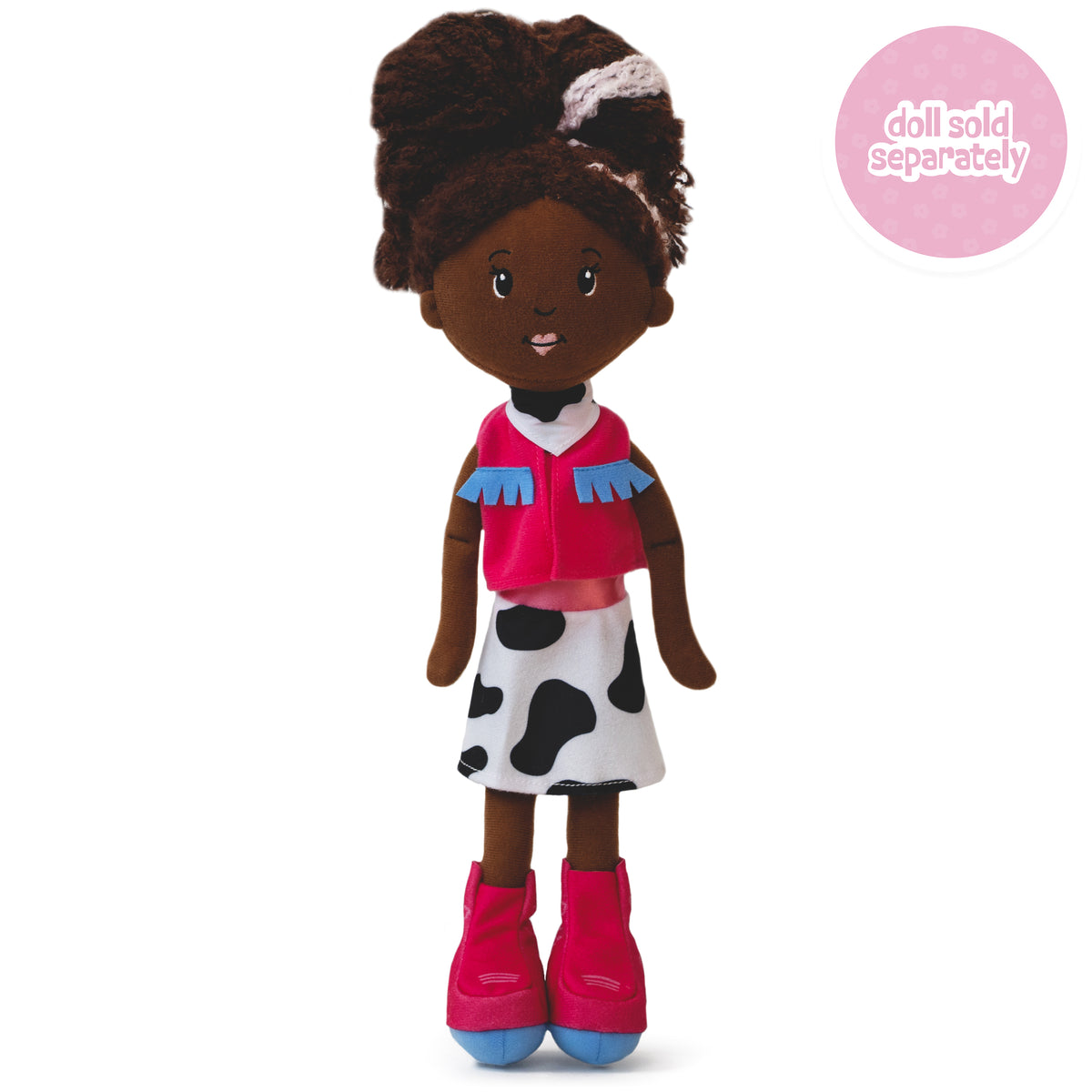 a soft doll wearing a pink cowgirl outfit with a vest, boots, cow print skirt and bandana.