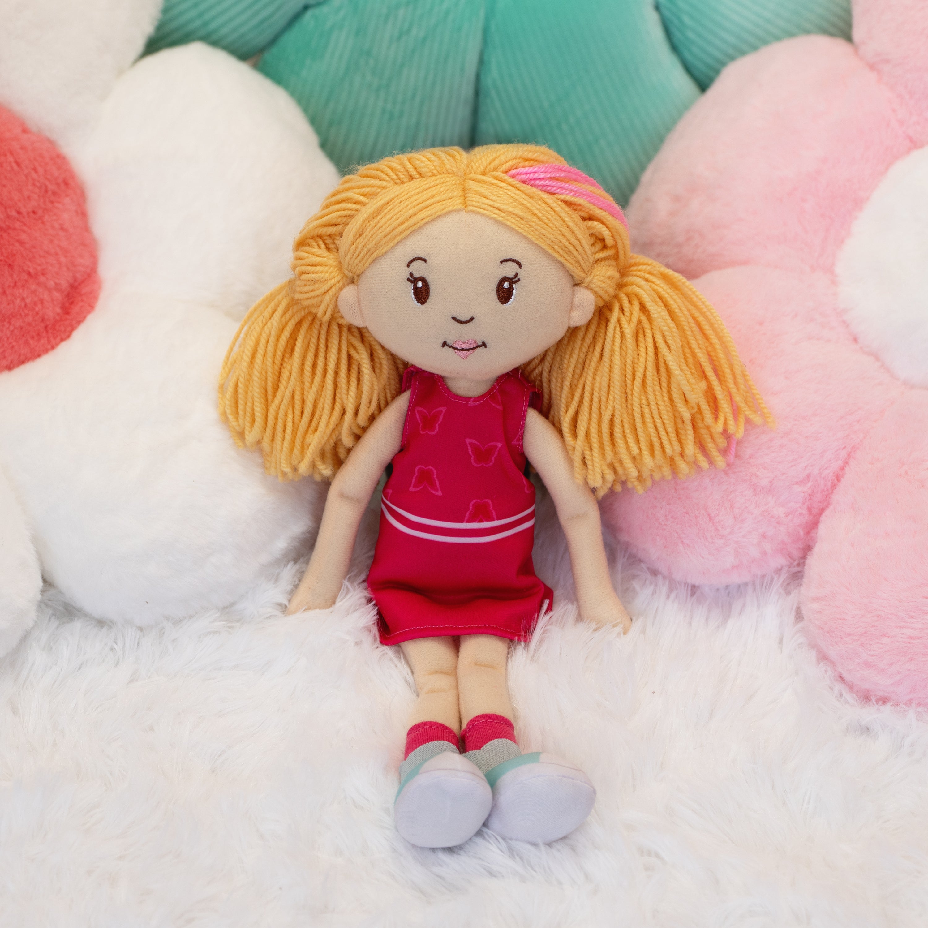 Groovy Girls Rose doll leaning on flower shaped pillows