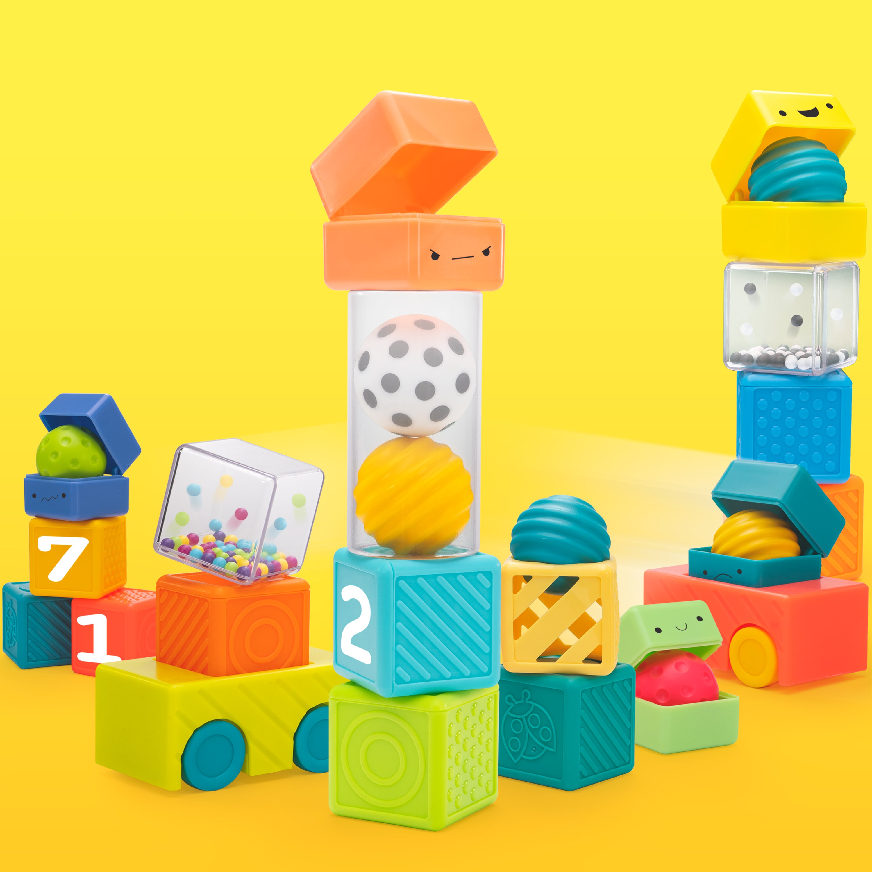 Colorful toy blocks with various shapes and textures on a yellow background