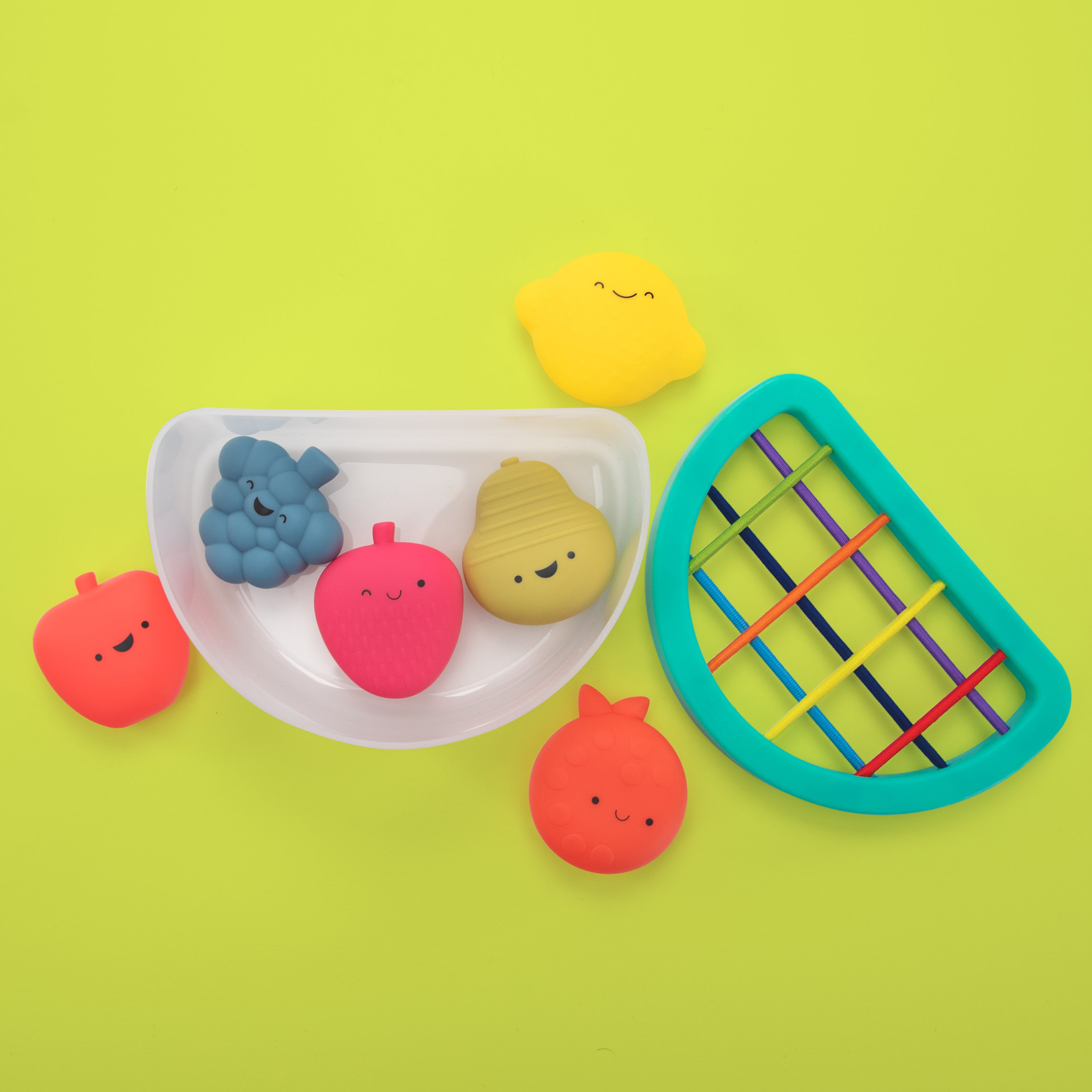 Colorful children's toys on a green background