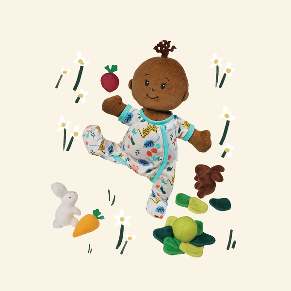 Style Your Own Wee Baby Doll posing with a garden play accessory.