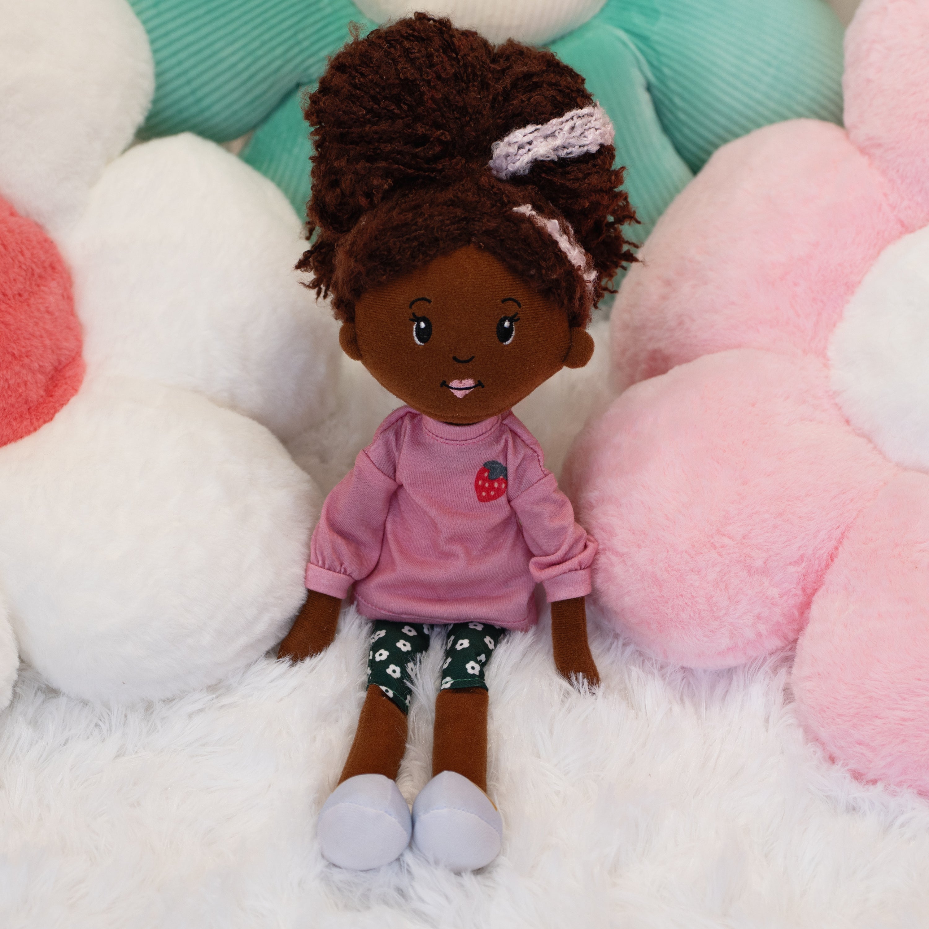 Groovy Girl Saige doll leaning on flower shaped pillows
