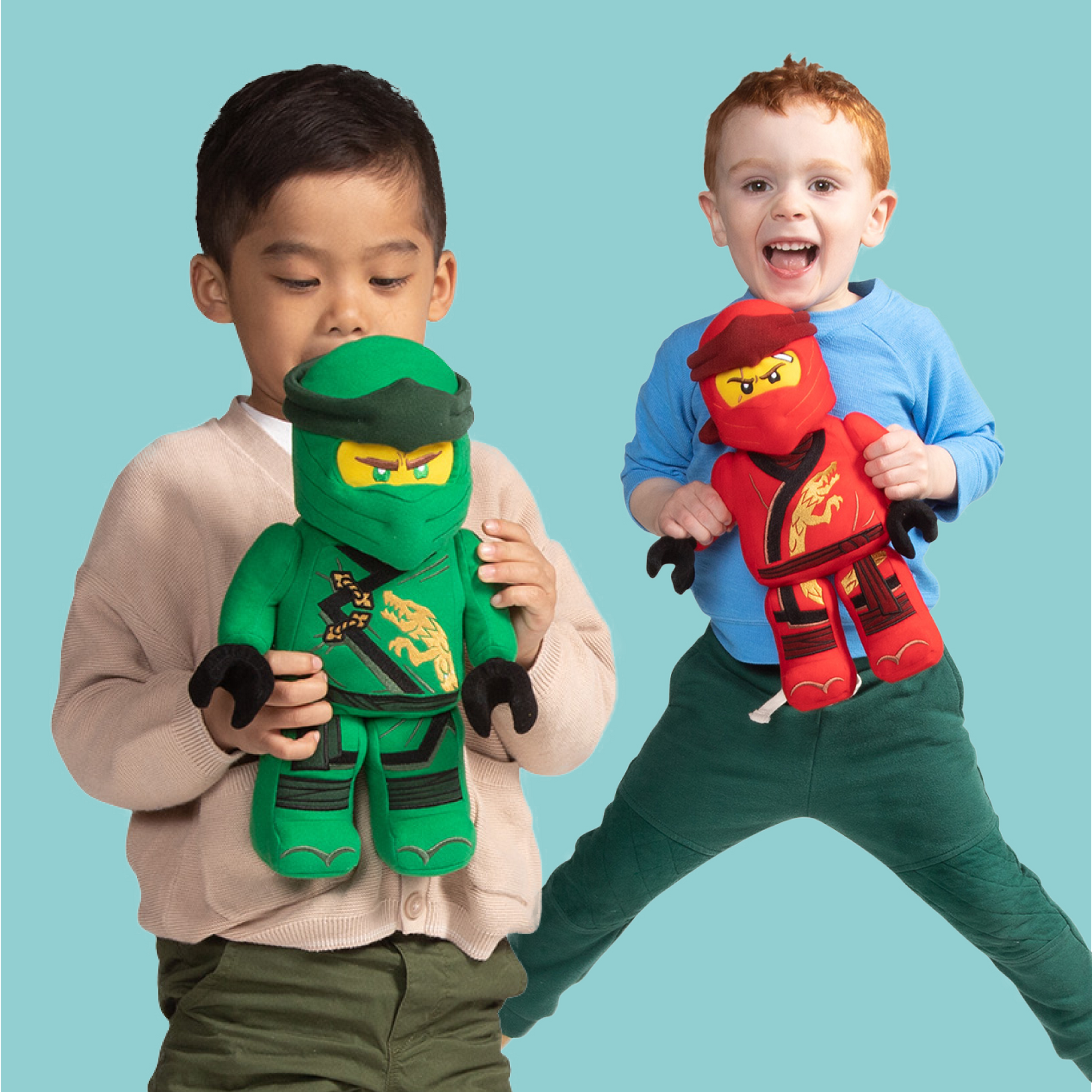 Two boys playing with LEGO Ninjago plush characters on blue background