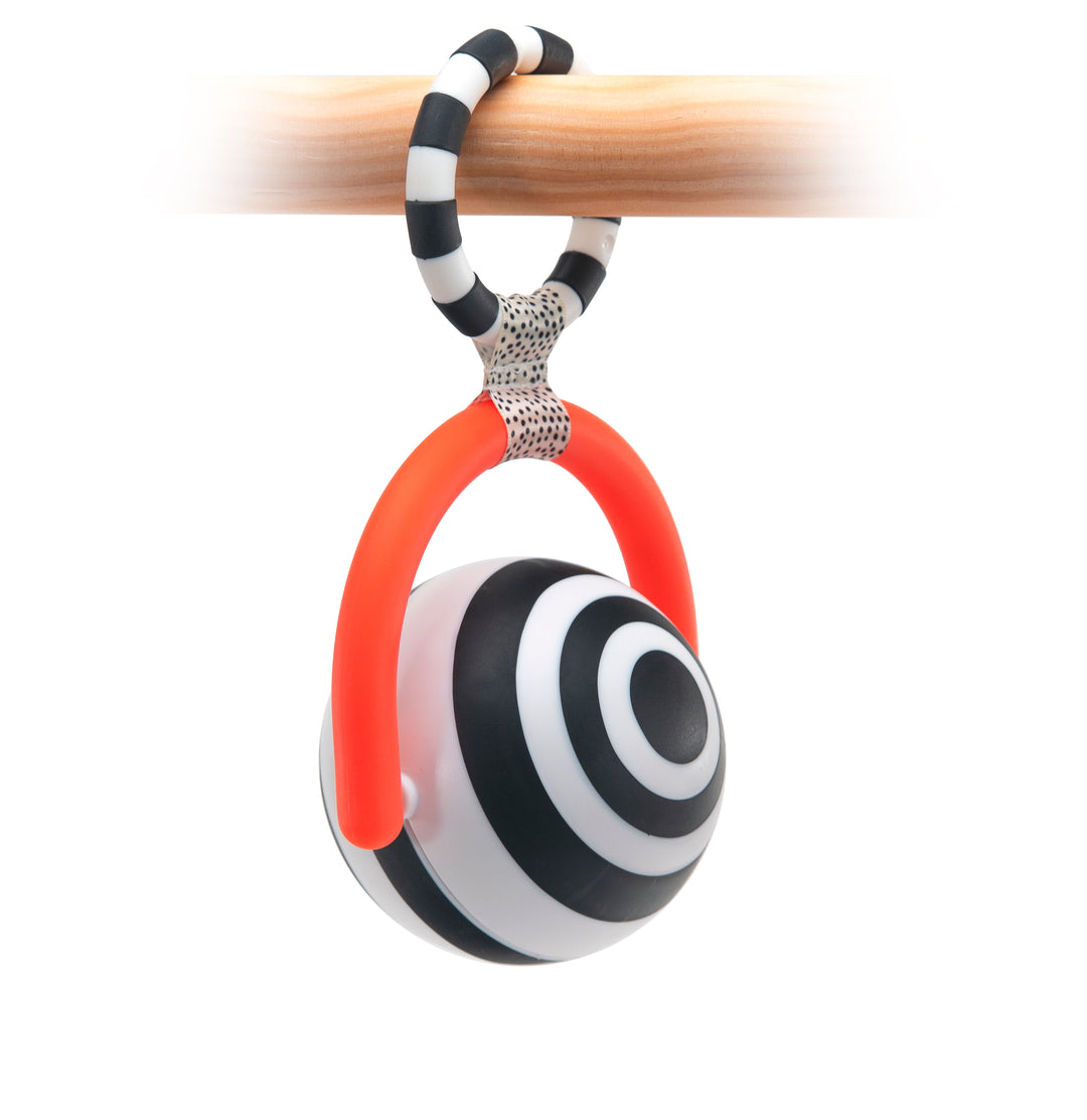 Black and white striped ball with red handle on a white background