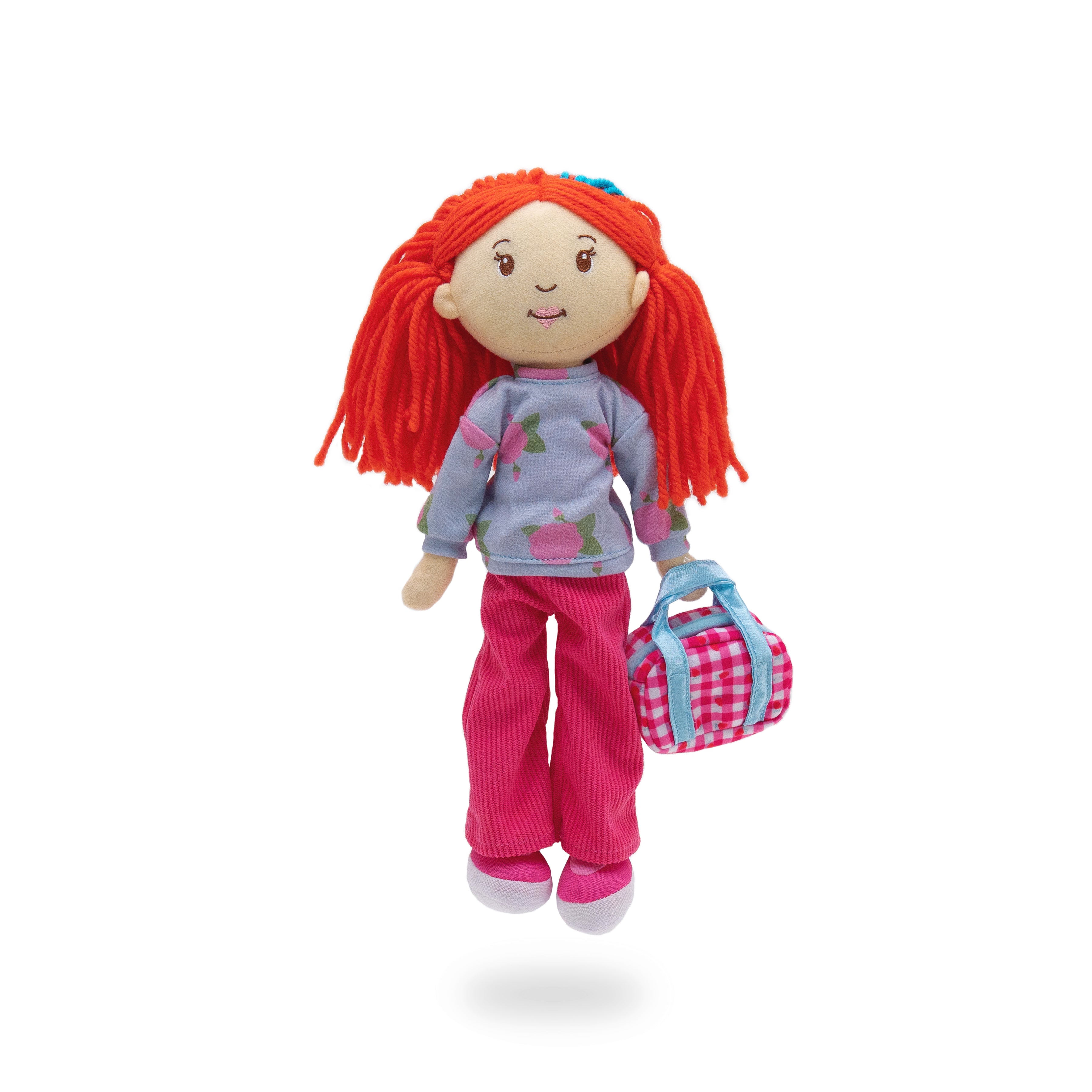 Soft doll wearing floral patterned shirt with pink corduroy pants, holding a pink duffel bag.