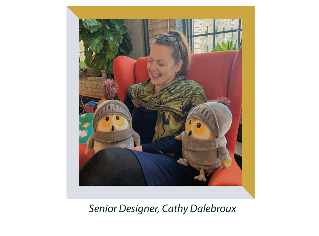 Manhattan Toy Senior Designer Cathy Dalebroux holds two Knight Owl plush,