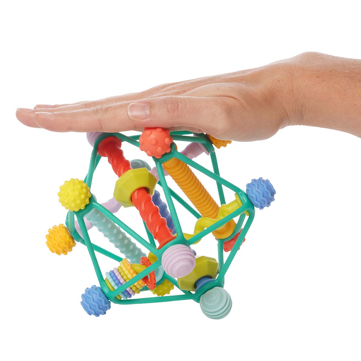 A hand rests on top of the Whirzle, an infant grasping toy made of colorful plastic rods and flexible plastic cording.