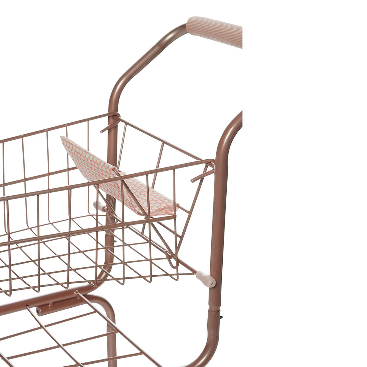 Close up of fabric doll seat cover on an aluminum pink toy shopping cart.