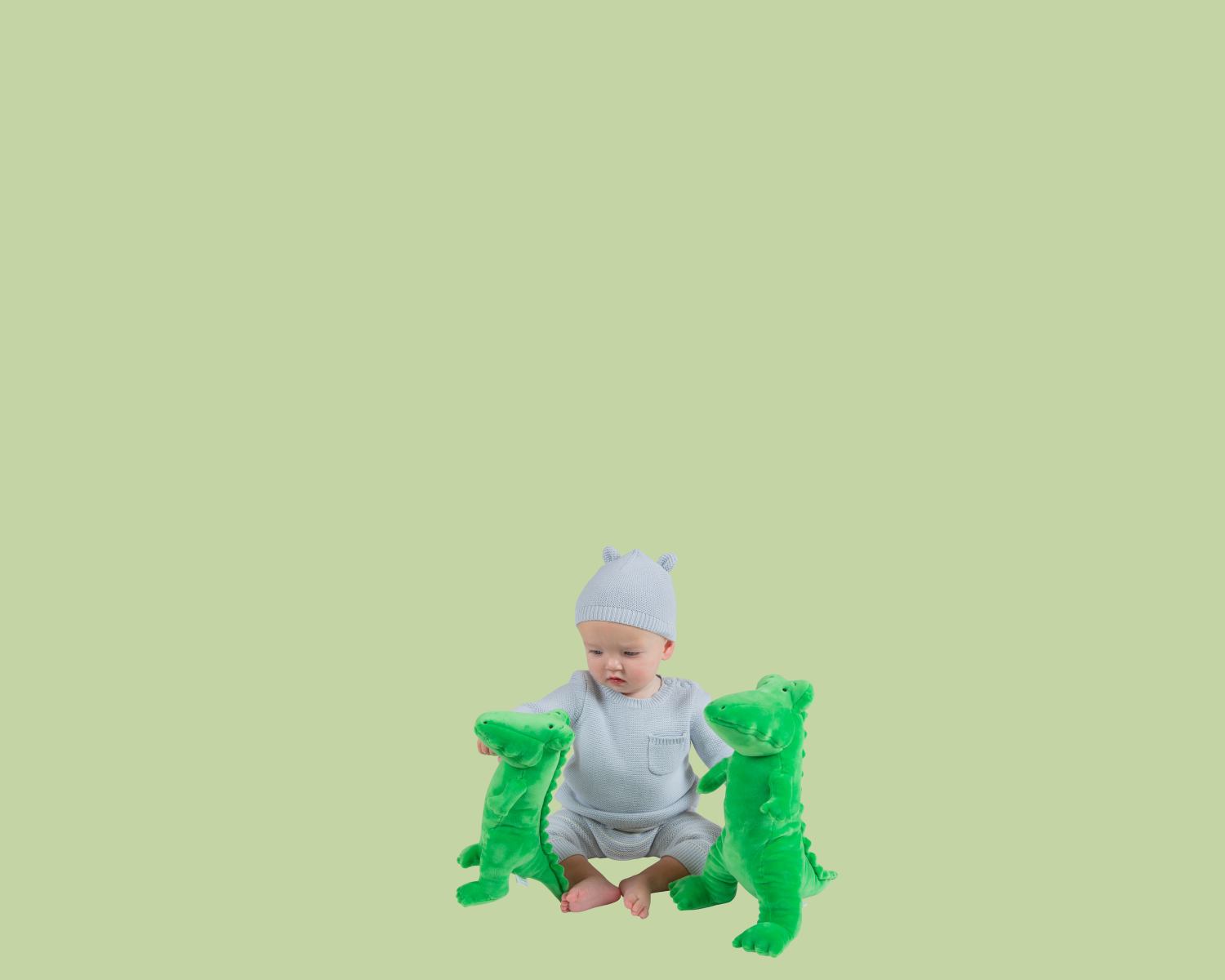 Child plays with small and large Lyle, Lyle, Crocodile plush.