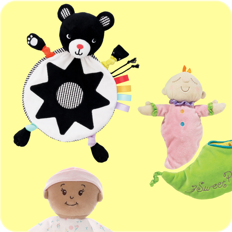 A black and white bear lovey, a pink snuggle doll and pea pod sack, and a soft baby doll peeking into frame on a pea green background.