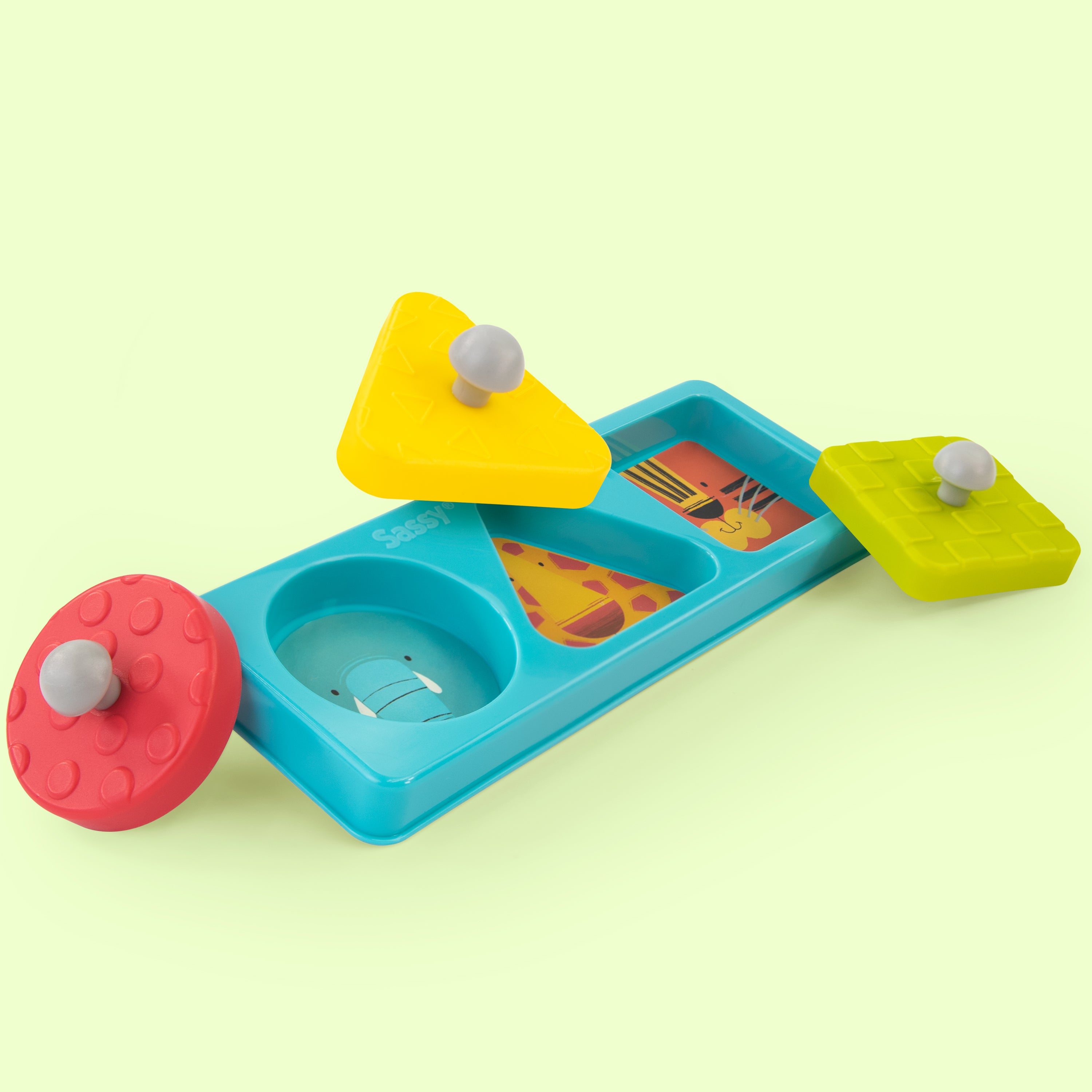Colorful toy with geometric shapes on a light green background