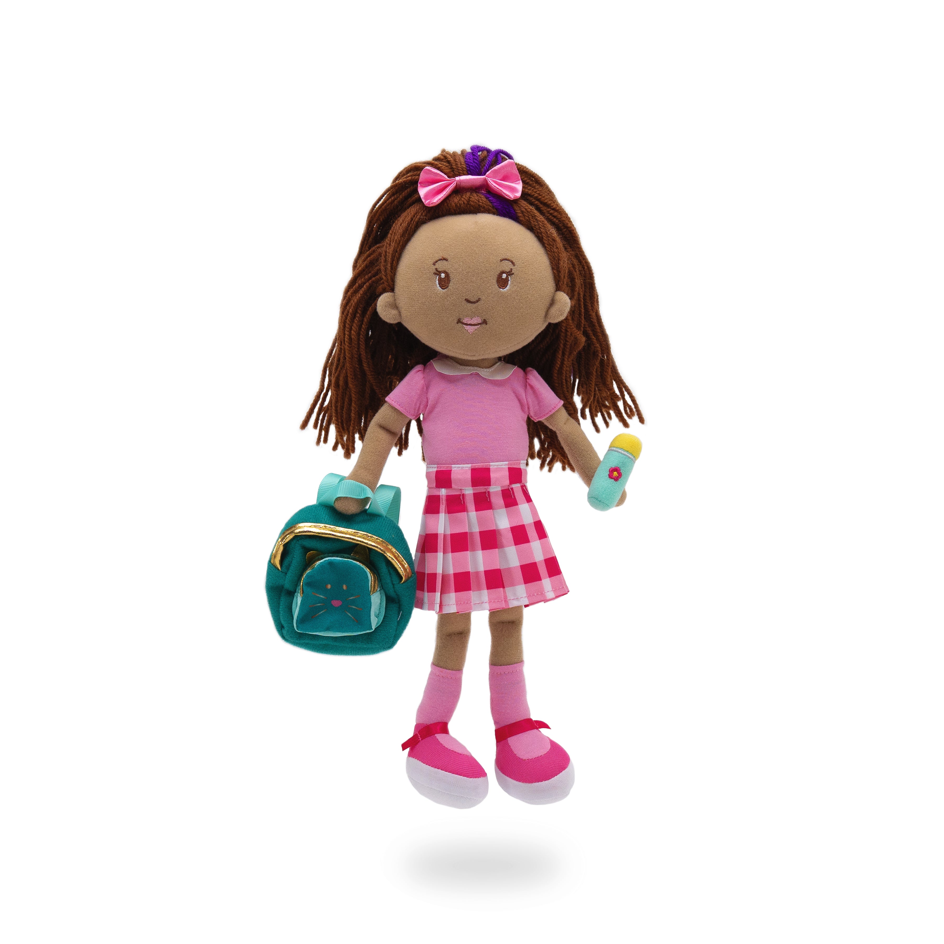 Soft doll wearing pink collared shirt, gingham skirt, holding a backpack and water bottle.