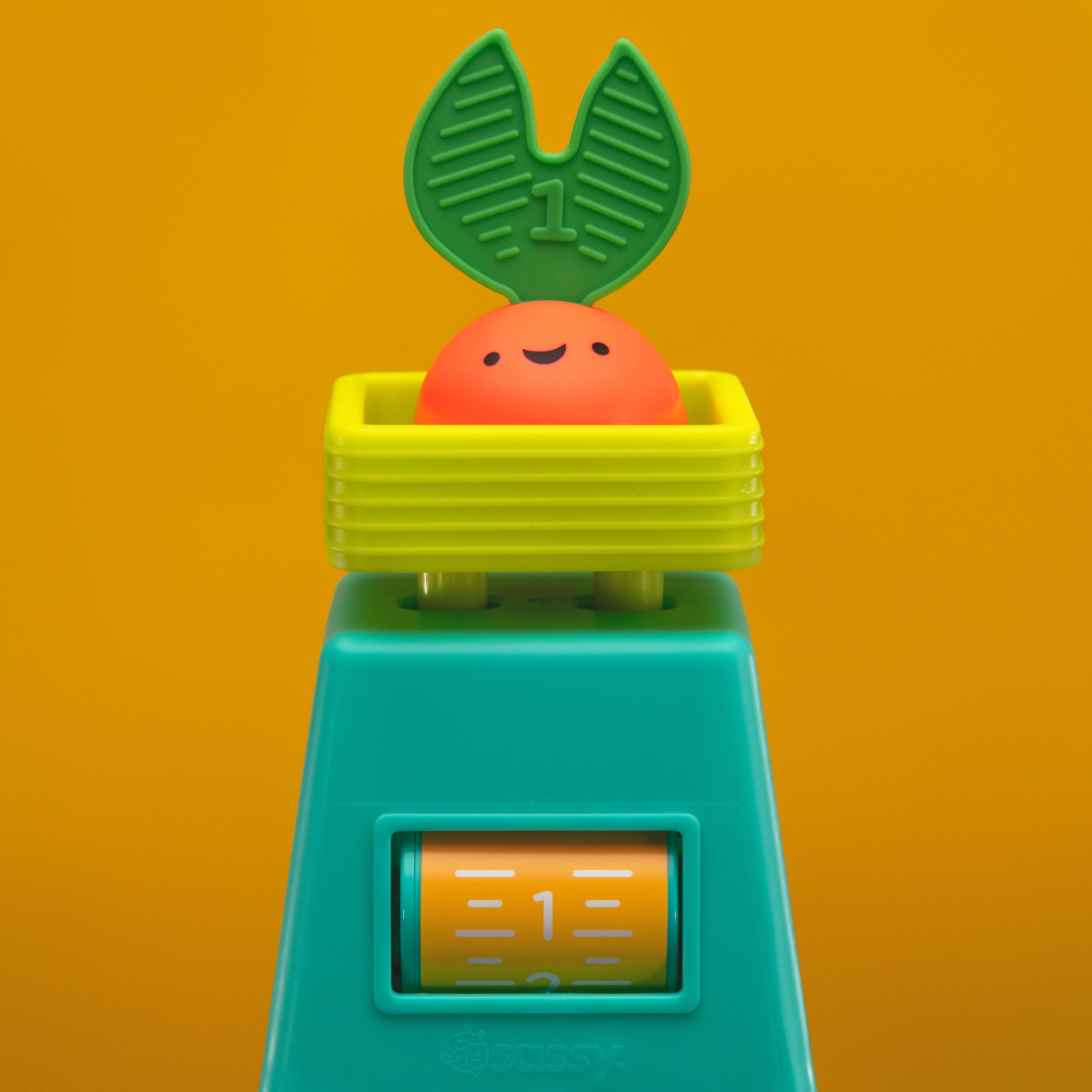 veggie stacker toy with red veggie piece on an orange background.