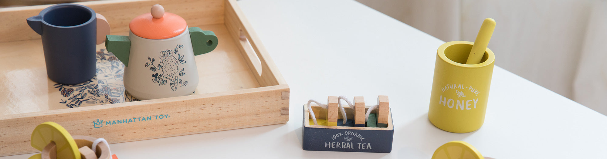 Tea party set on wood serving tray on table