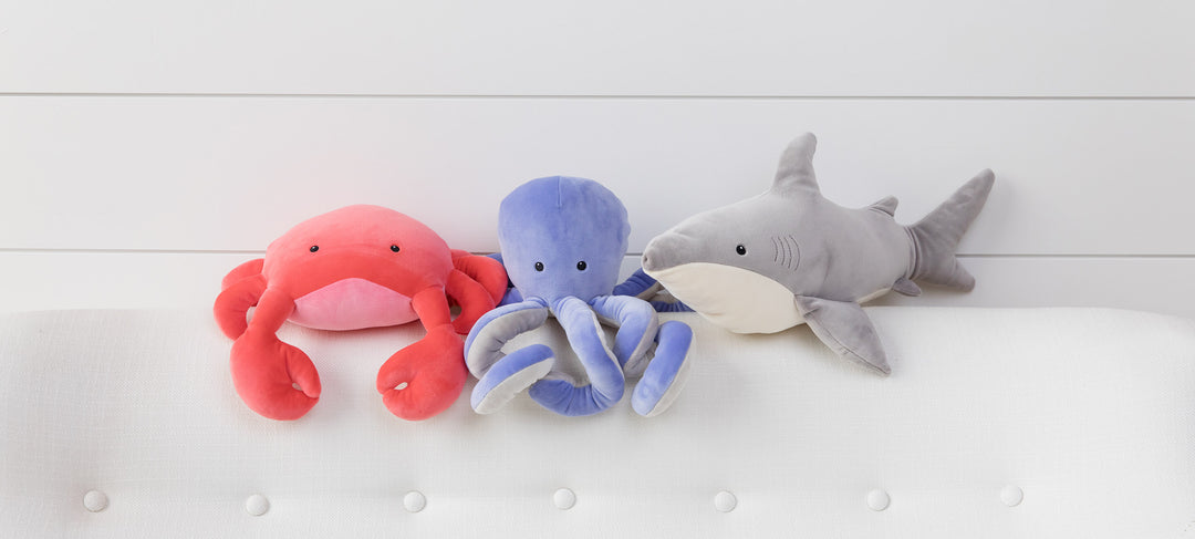 Sea creatures sitting on bed headboard against shiplap wall