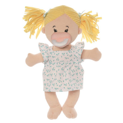 Peach skinned soft doll in a standing position with blonde hair pigtails wearing a dress with a pink pacifier on the face of the doll. 
