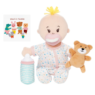 soft doll with peach skin dressed in pjs that comes with a stuffed teddy bear, baby bottle and mini paper picture book doll is seated holding teddy and bottle with magnetic pacifier on face
