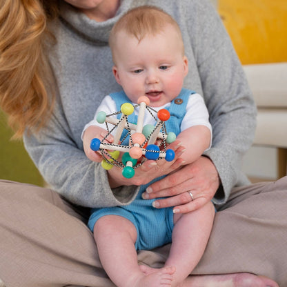 baby holding skwish toy