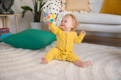 baby holding on the click clack ball