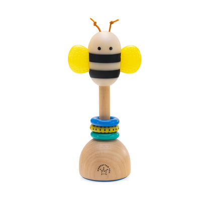 Bee themed wooden baby rattle with yellow textured wings and colorful stacking rings on a natural wood base.