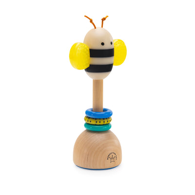 Bee themed wooden baby rattle with yellow textured wings and colorful rings on a natural wood base.