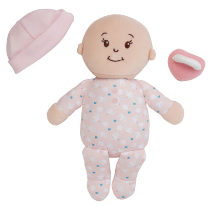 peach skinned soft baby doll with removable beanie and magnetic pacifier off to side of doll
