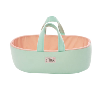 blue and peach colored fabric doll sized bassinet with handles and a love stella logo