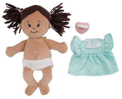beige soft baby doll with brown pigtails with blue dress removed and pink pacifier off to the side to show the fabric belly button and included removable fabric diaper