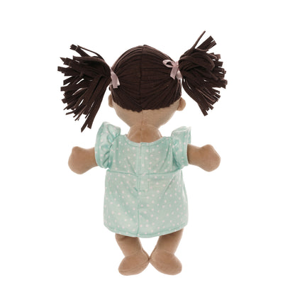back side of soft baby doll with beige skin and brown pigtails wearing a dress with a magnetic pacifier