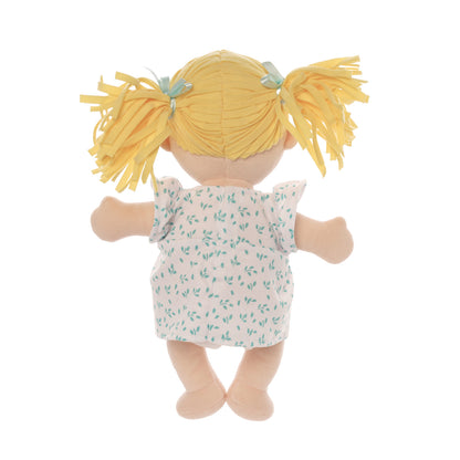 Back side of peach skinned soft doll with blonde pigtails wearing a blue and white dress.