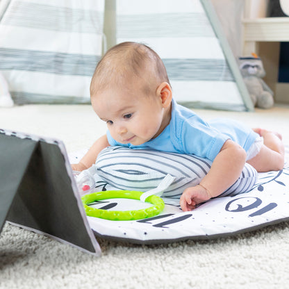 Baby playing with a toy on a mat in a home setting