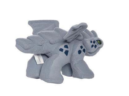 Gray baby dragon plush inspired by LEGO Ninjago shown in side view with green embroidered eye, dark blue scale patches, and quilted wings.