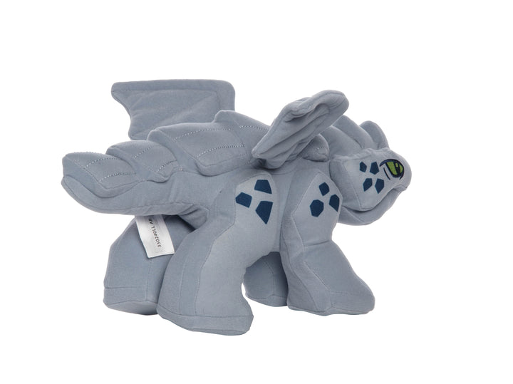 Gray baby dragon plush inspired by LEGO Ninjago shown in side view with green embroidered eye, dark blue scale patches, and quilted wings.