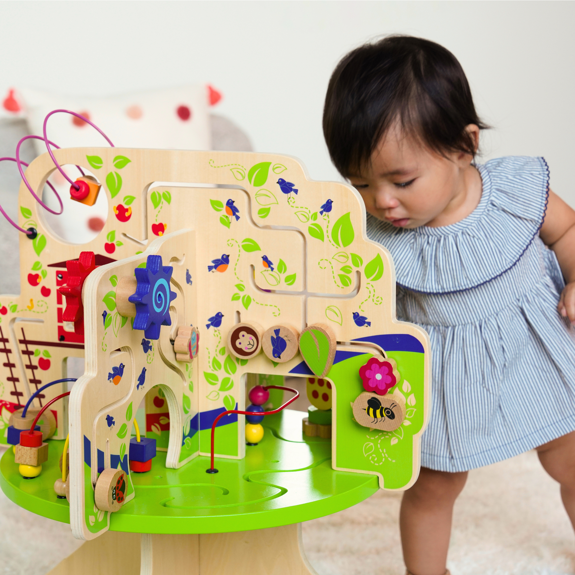 photo of toddler playing with a playground adventure play table