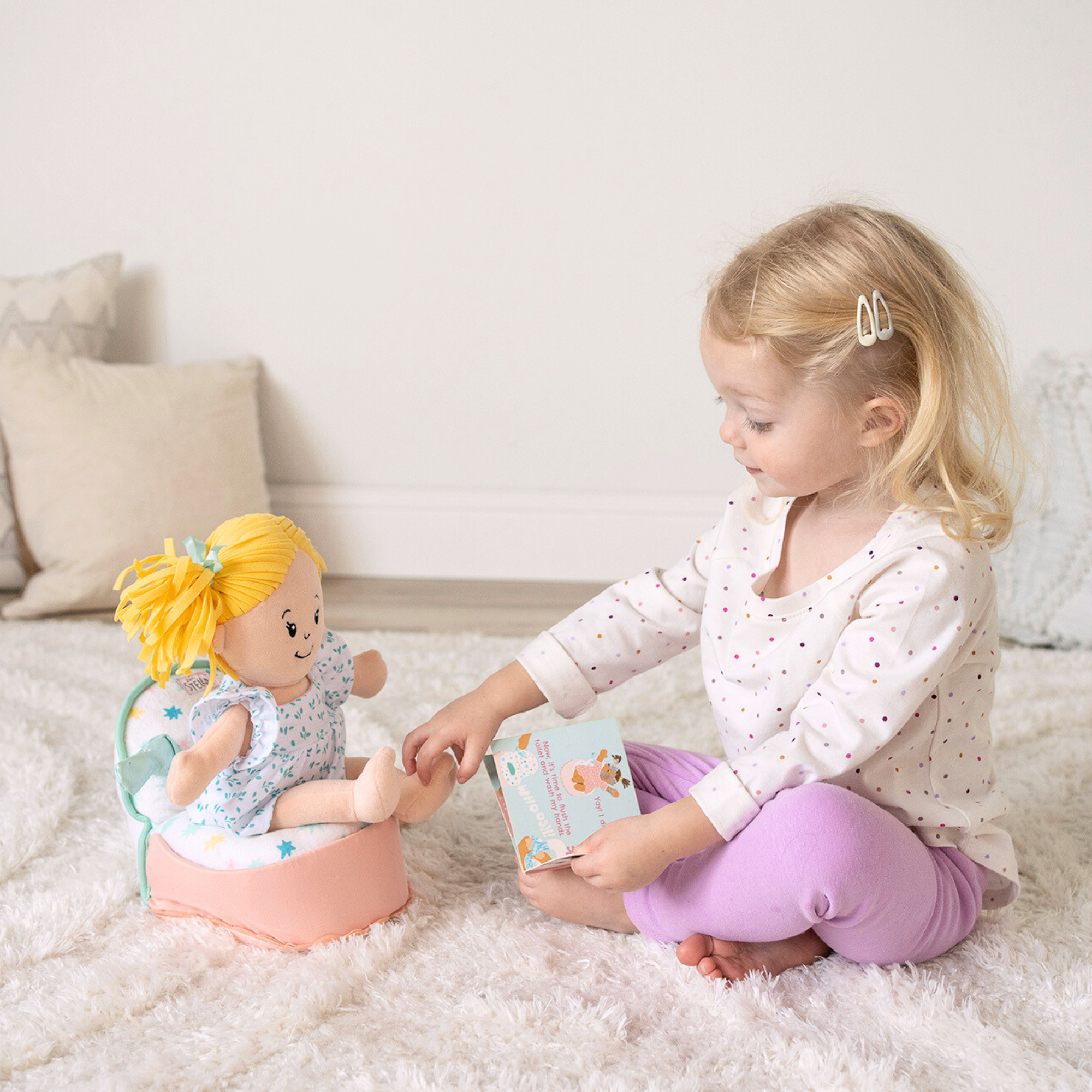 Baby playing with colorful developmental toy featuring high-contrast patterns and textured shapes.
