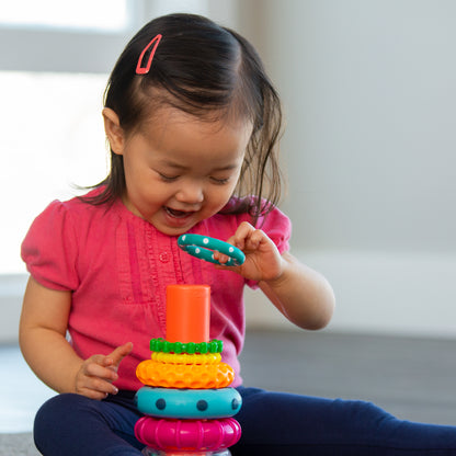 little girl playing with ring  stacker toy