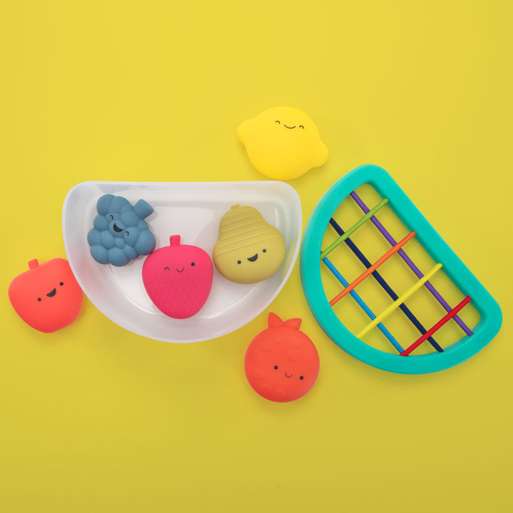 Colorful bath toys on a yellow background
